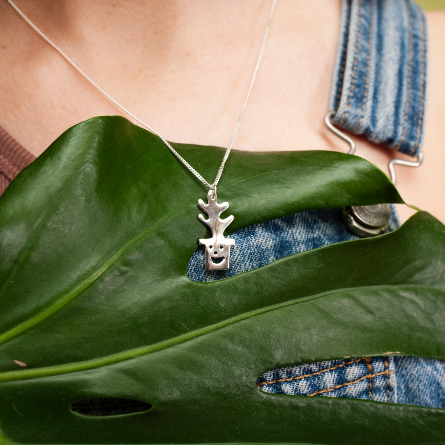 Close up of silver Smiley Plant Pot Necklace