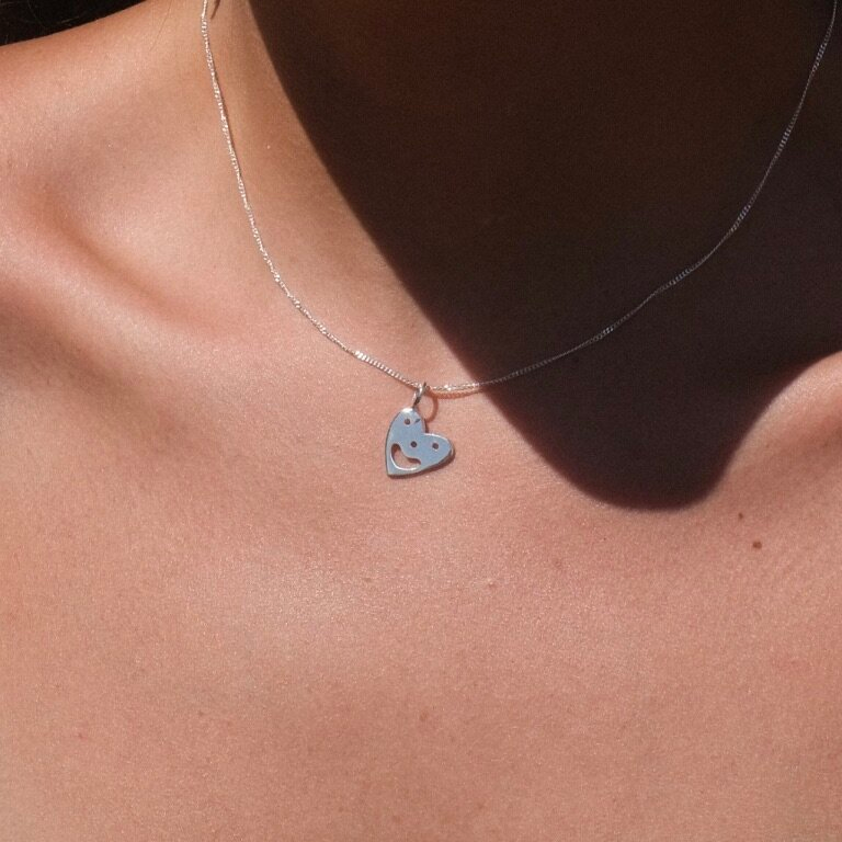 Pendant chain necklace with a smiling heart charm