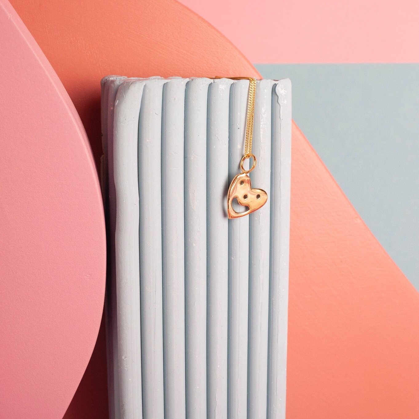 Pendant chain necklace with a smiling heart charm