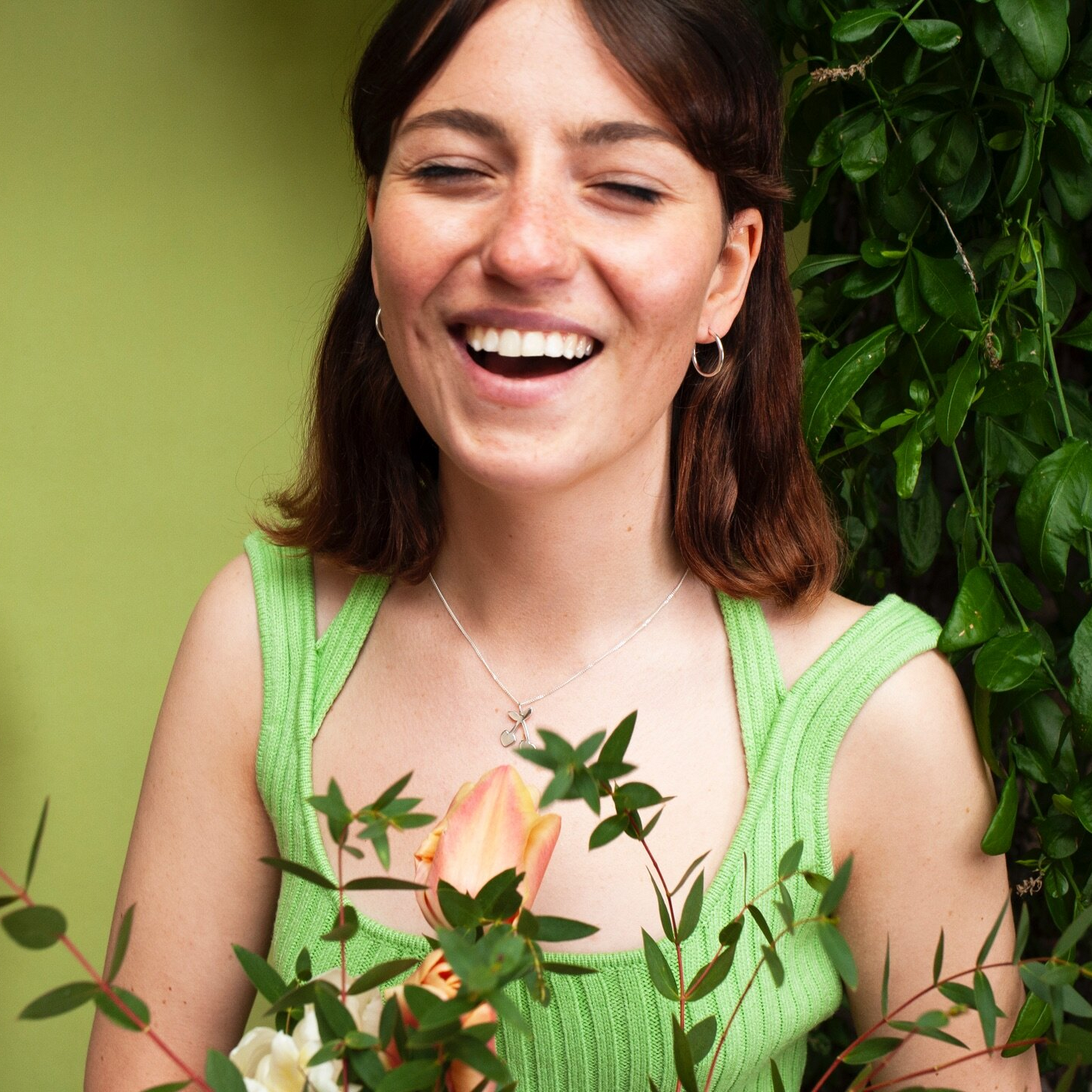 Woman wearing small silver hoop earrings