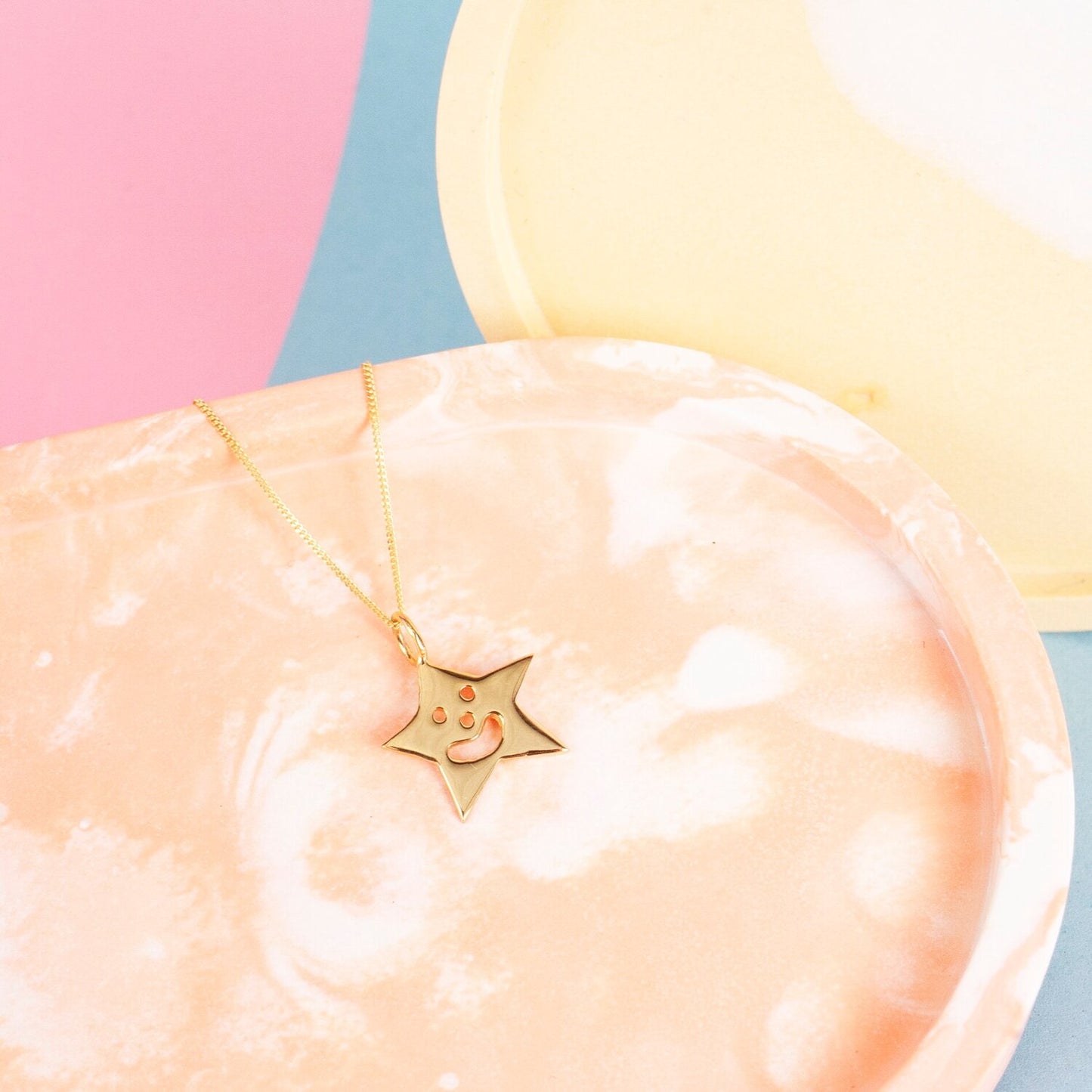 Close up of gold Smiley Star Necklace