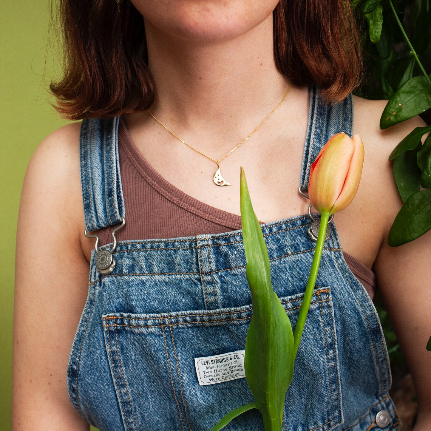 Woman wearing gold Smiley Moon Necklace
