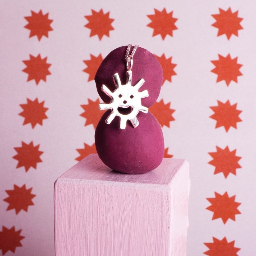 Close up of silver Smiley Sun Necklace