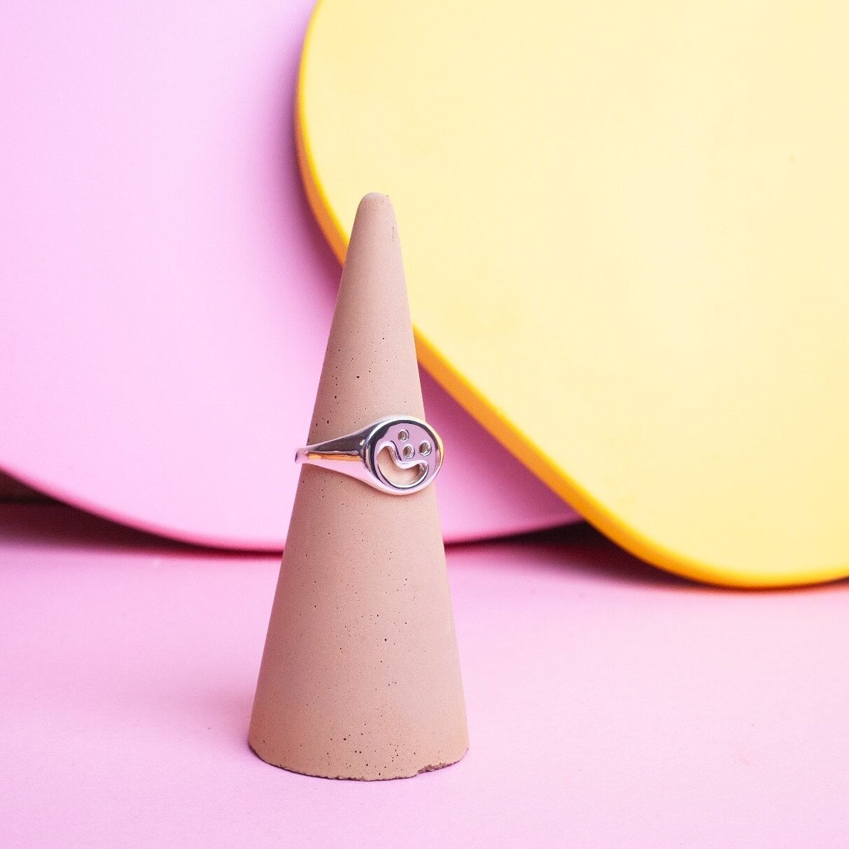 Close up of silver Smiley Signet Ring