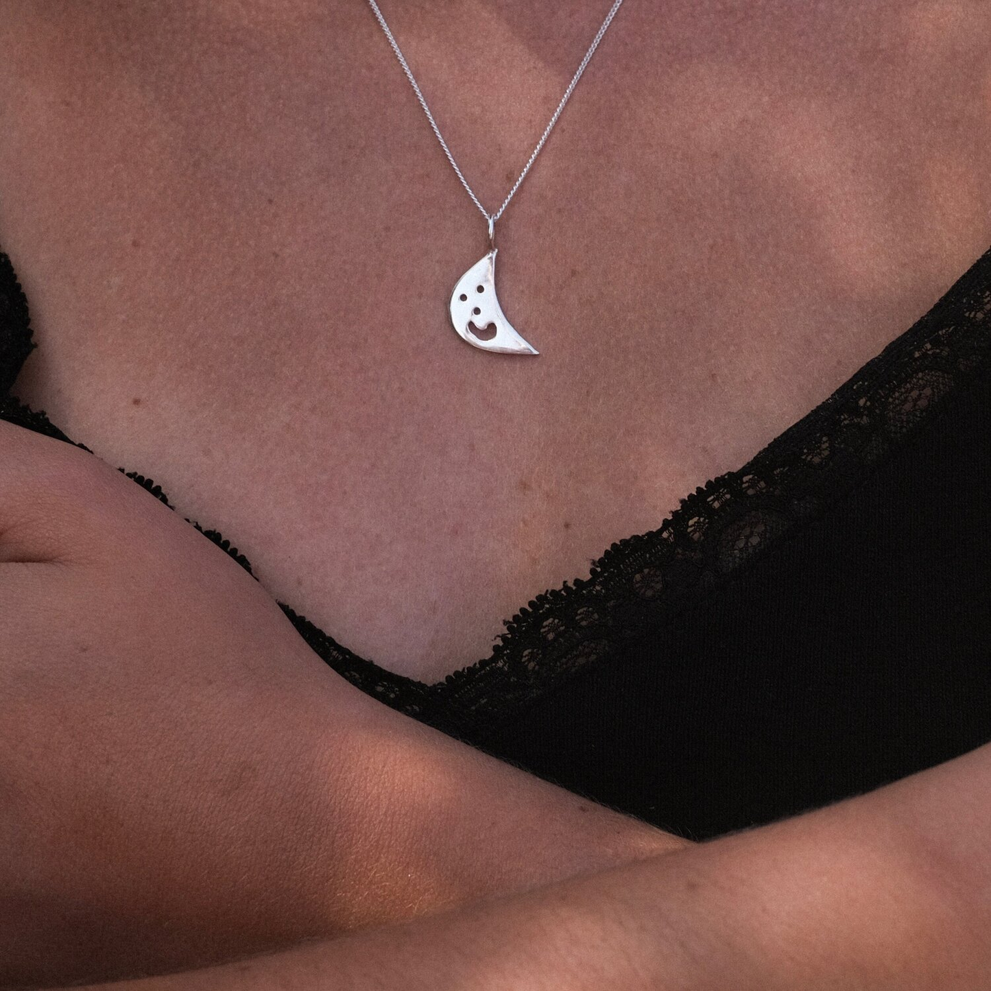 Close up of silver Smiley Moon Necklace