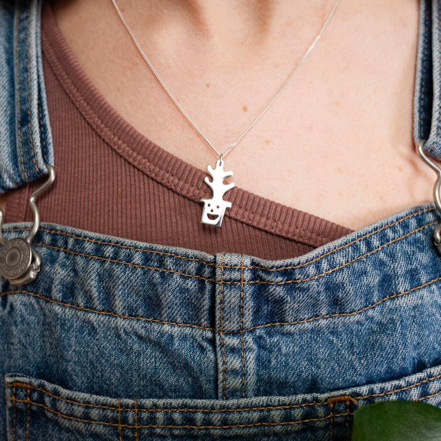 Close up of silver Smiley Plant Pot Necklace