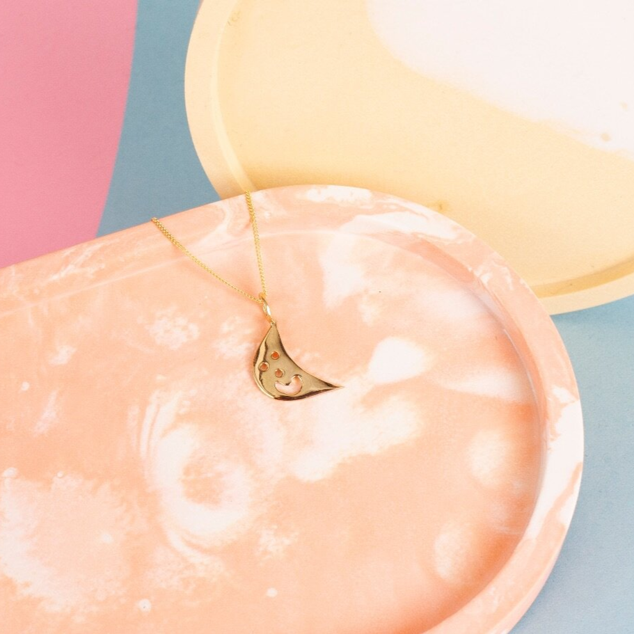 Close up of gold Smiley Moon Necklace