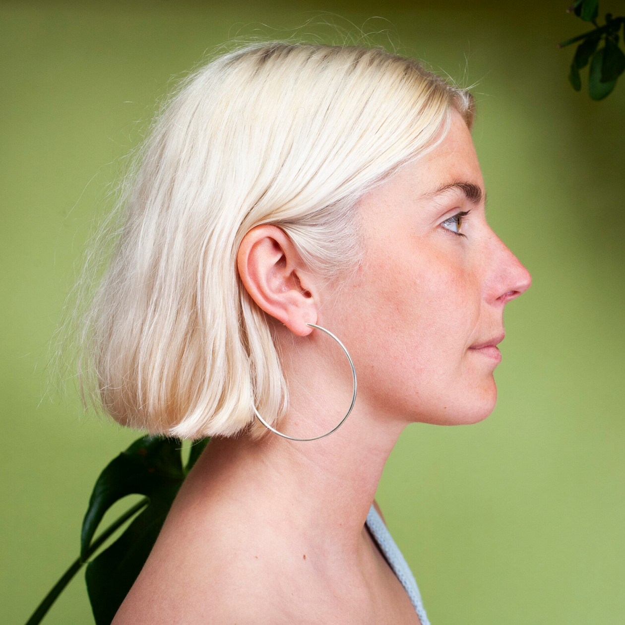 Woman wearing large silver hoop earring