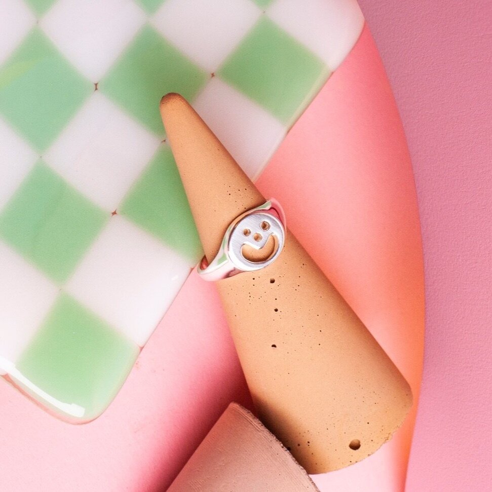 Close up of silver Smiley Signet Ring