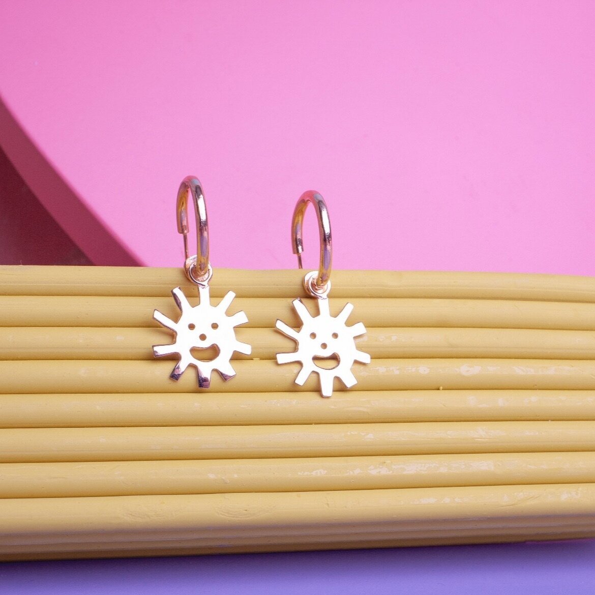 Close up of Smiley Sun Hoops earrings