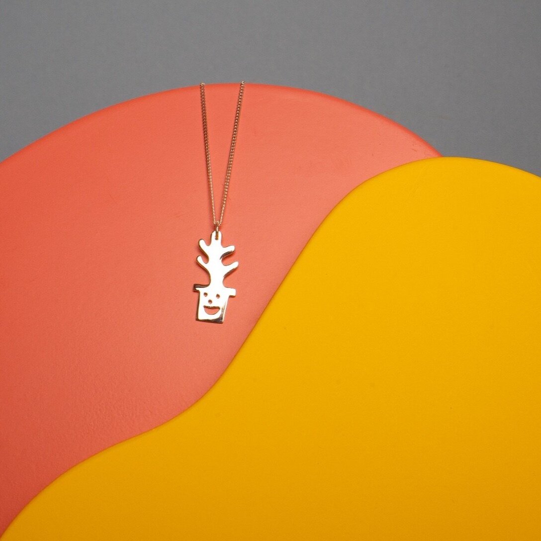 Close up of silver Smiley Plant Pot Necklace