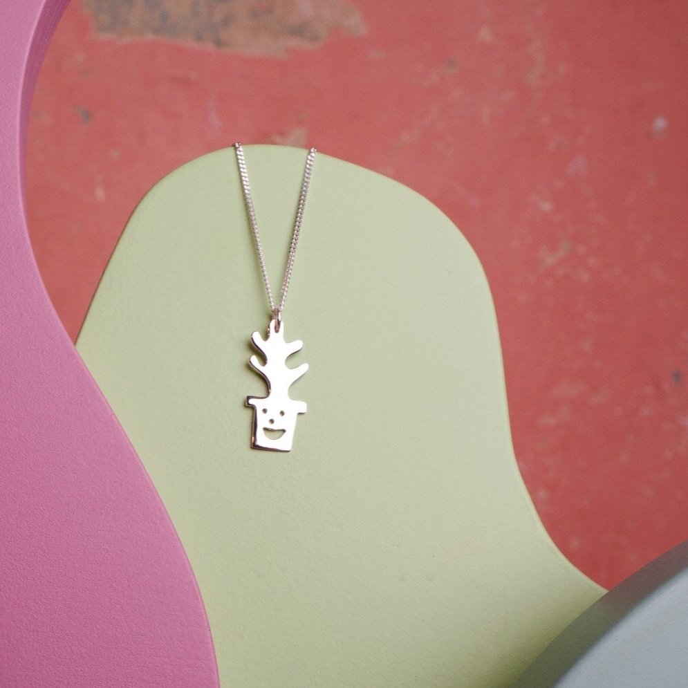 Close up of silver Smiley Plant Pot Necklace