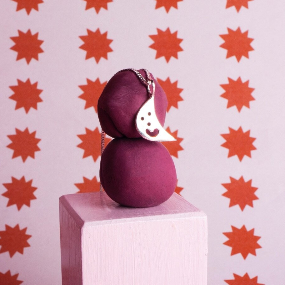 Close up of silver Smiley Moon Necklace