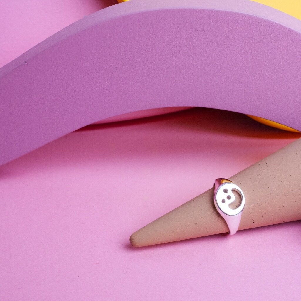 Close up of silver Smiley Signet Ring