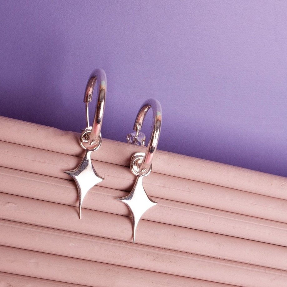 Small hoop earrings with a star shaped charm